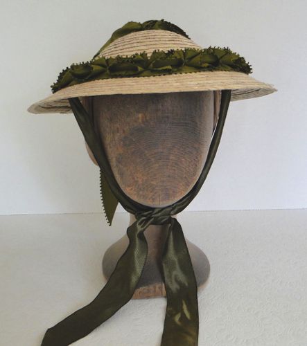 This style was popular for “gardening”. Taffeta ribbons tie under the chin and a comb helps to keep this hat in place.
