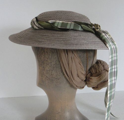 The straw is taupe paper straw, which started as a modern sun hat and was unpicked and then re-stitched into a new shape.