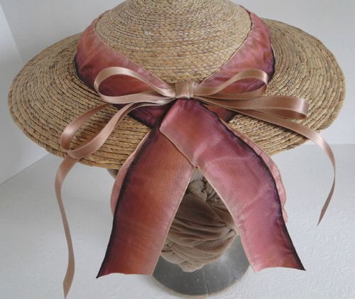 The back of the hat has short trailing ribbons and a bow of narrow pink satin.