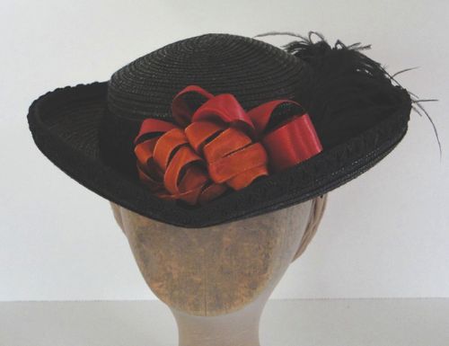This black straw hat started as a second-hand acquisition.  The crown was shortened, and the brim re-shaped before trimming.