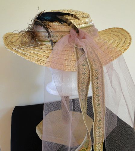 Jacquard ribbon, pink tulle, and pheasant feathers trim this garden hat.