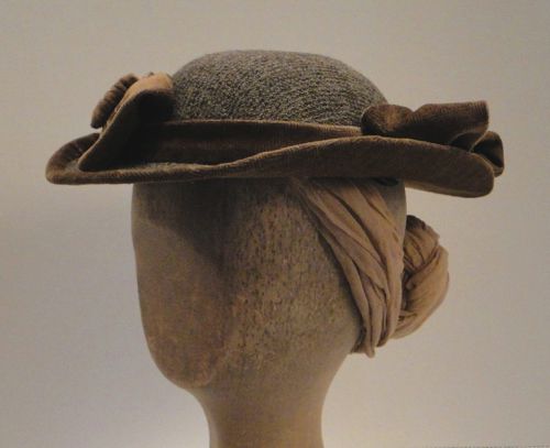 Horsehair tabs and an elastic cord are used to hold the hat in place.