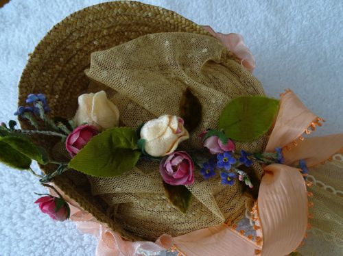 This is a top-down detail view of the crown which shows the flowers, the net, and the half-bow of picot ribbon.