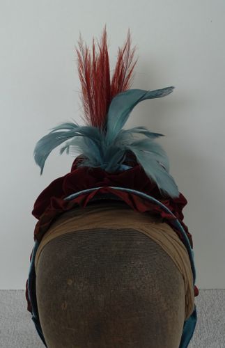 Detail view of the stand-up feathers.  The turquoise ones are rooster tail feathers and the rust ones are vintage burnt schlappen feathers.