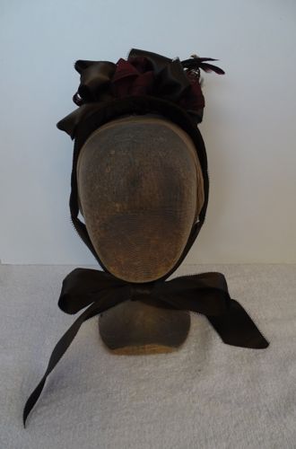 The bonnet was made on a buckram and wire frame that was covered with brown velvet.