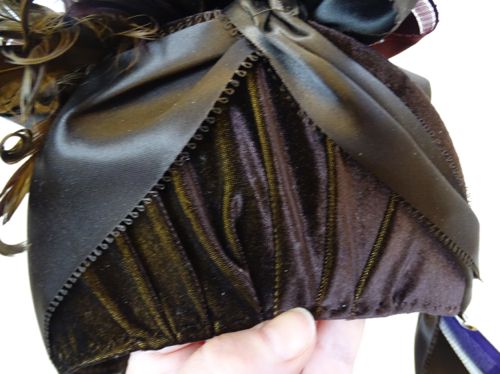 Detail of the velvet pleated at the back of the bonnet, and the satin ribbon with feather edge.