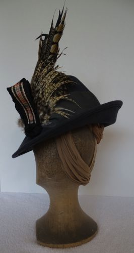 The brim was wired and covered with grosgrain, then turned up in the back and down in the front.