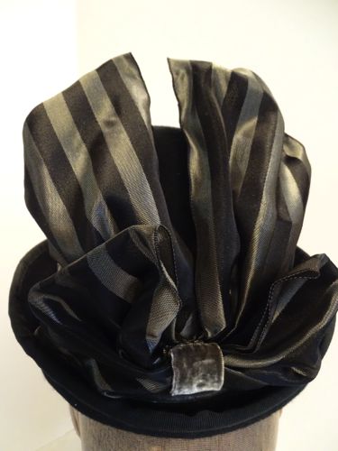 Double loops were made from a wide striped taffeta ribbon.  This ribbon was wired, helping the loops stay erect.  The loops were joined with a half-width band of velvet ribbon.