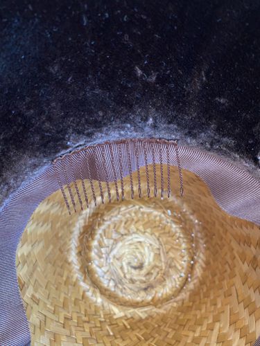 A wire hair-comb was stitched in at the join of crown and brim to catch into the hair and keep the bonnet from sliding off the head.