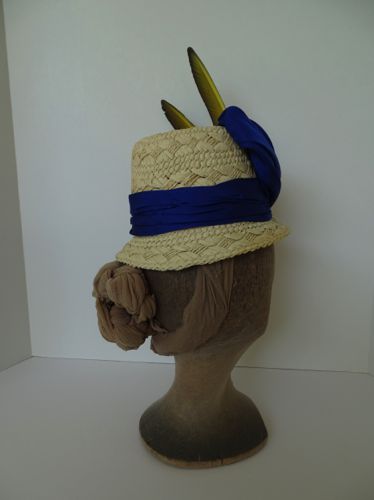 The back view shows off the pleating in the hat band, and the back of the feathers, which have a different color than the front.