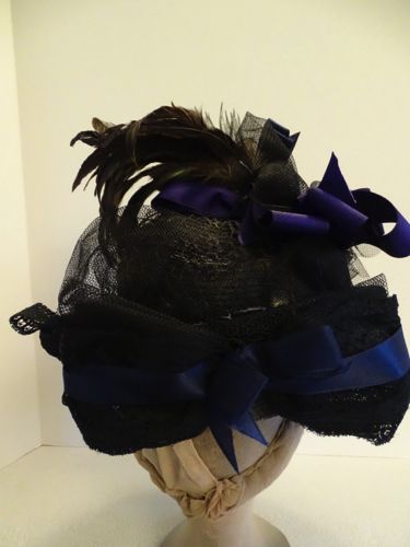 A large tailored bow trims the back and covers a split in the brim.  The split was made in order to form the turn-up.