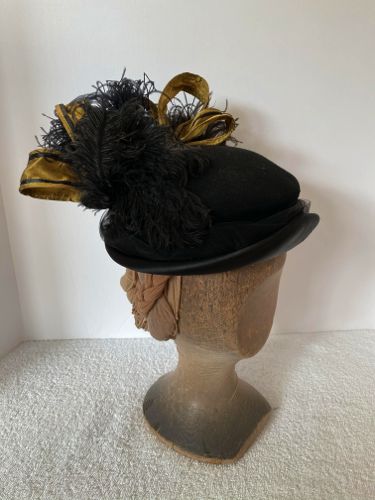 The loops and feathers add the requisite height to this hat, typical of the 1890's
