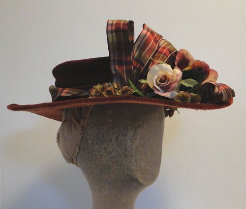 Plaid ribbon is wired to give height to the hat.
