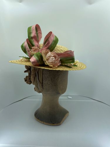 Straw boater made in 2021 with pink and green trims.
