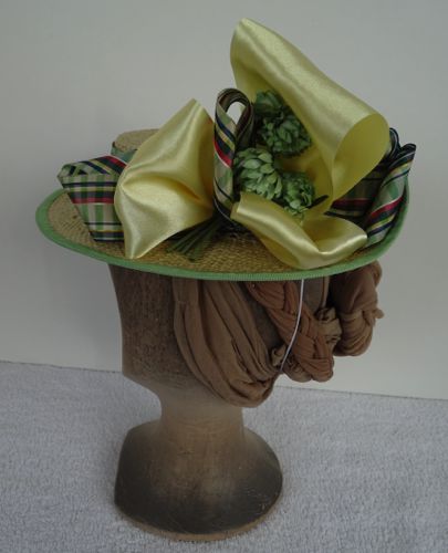 This shallow-crowned straw boater was formed on a hat block custom made by my dad.  The trims are green plaid taffeta and yellow satin ribbons.