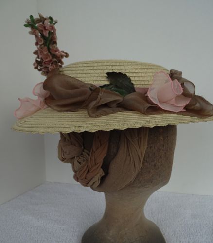 Other decorations on this hat are small ivory velvet flowers and a few rose leaves.