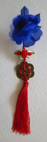 Clip-in hair decoration with tassels, coins and one blue flower.